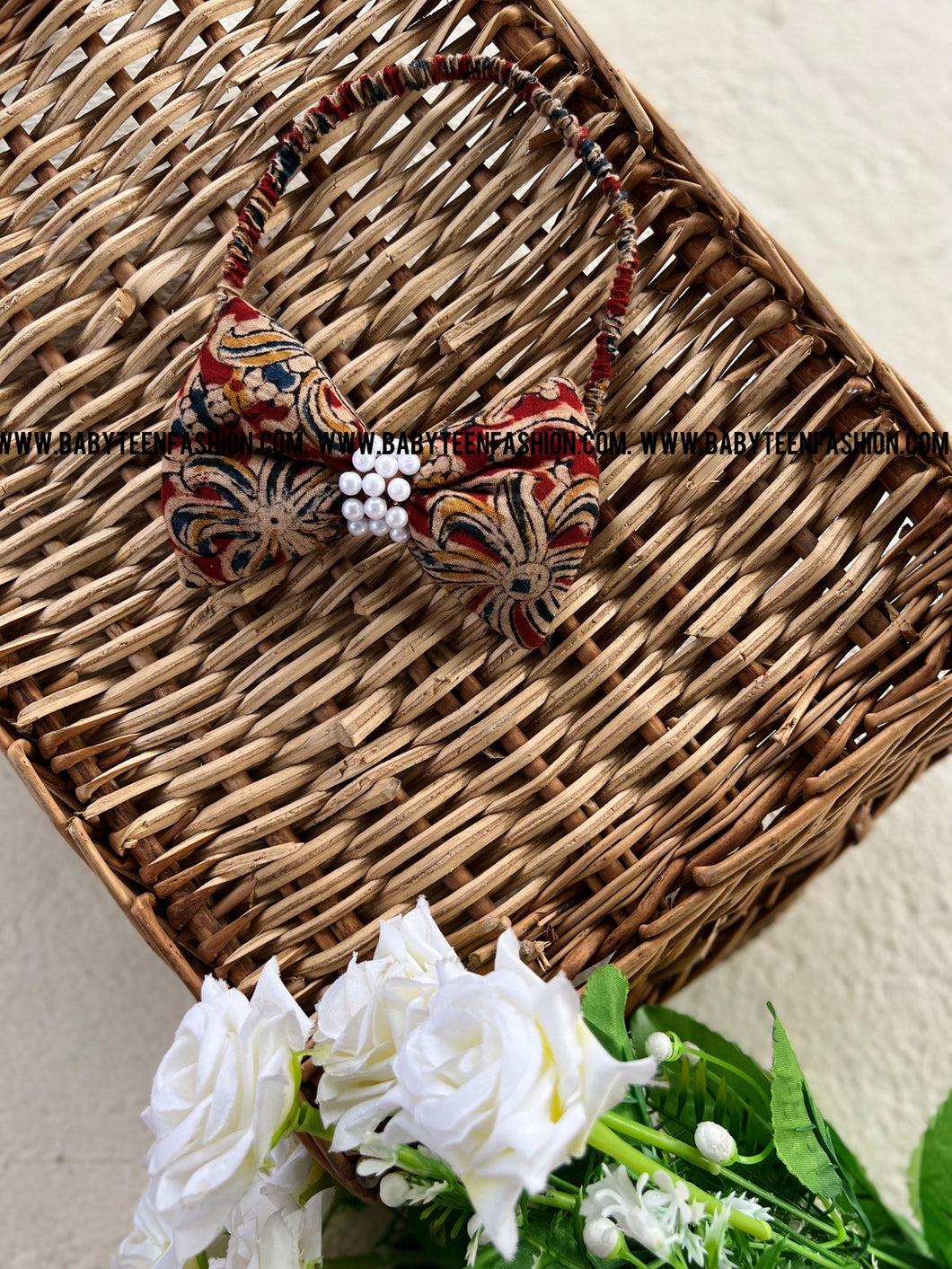 Quarter inch elastic band with sponge filled Pearls  embellished bow.